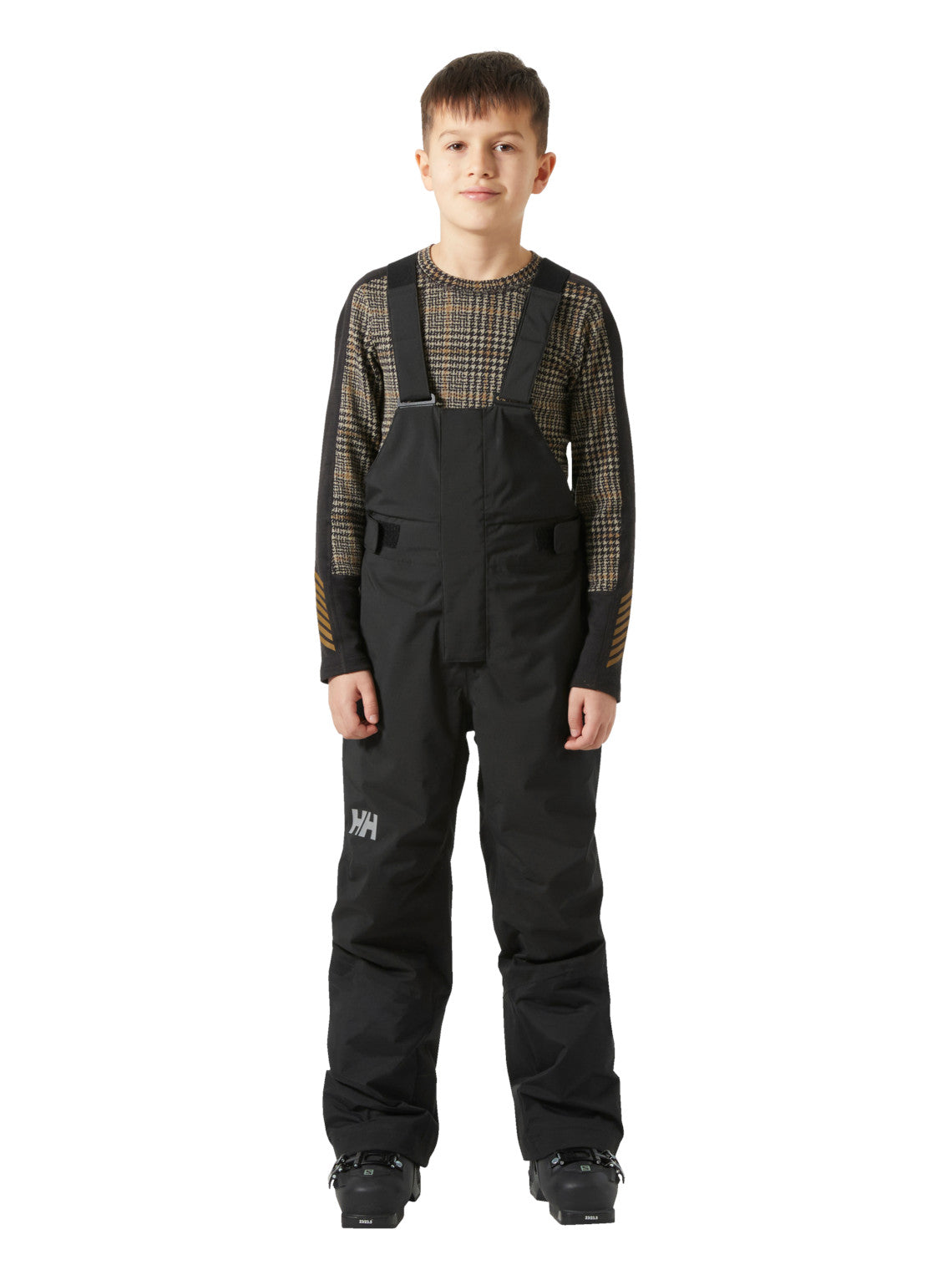 Helly Hansenin mustat lasten ja nuorten korkeavyötäröiset Bib pants -lasketteluhousut lapsen päällä edestä kuvattuna.