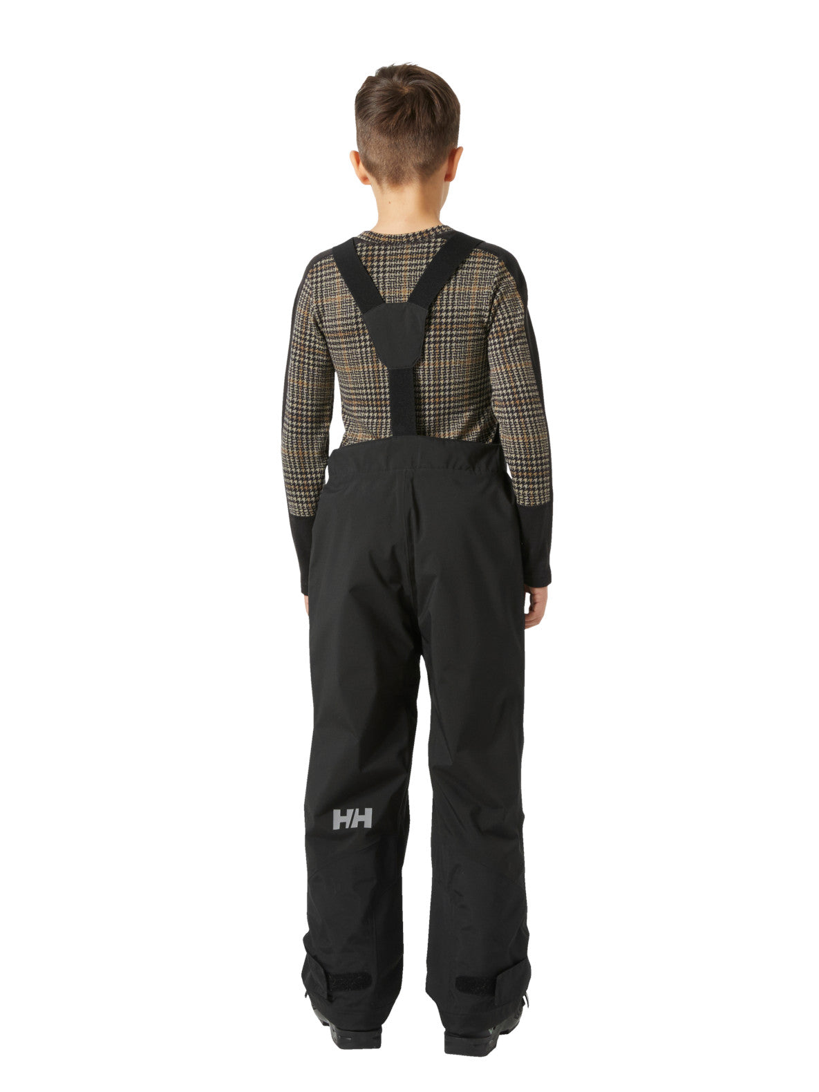 Helly Hansenin mustat lasten ja nuorten korkeavyötäröiset Bib pants -lasketteluhousut lapsen päällä takaa kuvattuna.