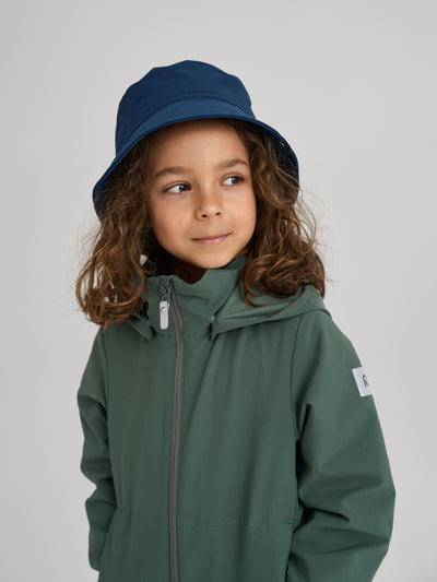 Reiman sininen anti-bite Itikka-kesähattu lapsen päässä, jolla on vihreä takki