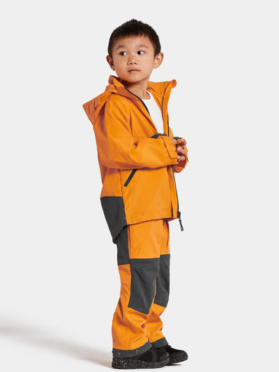 Pojan päällä Didriksonsin Stigen Lasten keltainen takki sivusta kuvattuna